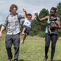 4 The Outdoors A family walks though a grassy field at William O'Brien State Park in Minnesota.